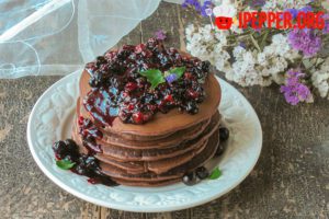 Chocolate pancakes with berry sauce