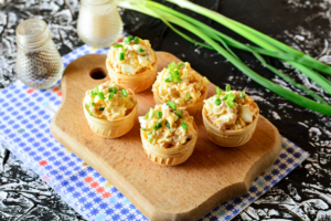Tartlets with cod liver and cheese