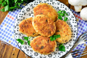 Meat cutlets with mushrooms in a frying pan