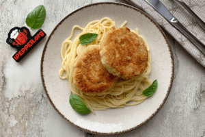 Minced chicken cutlets in a frying pan