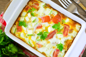 Lush omelette with zucchini and tomatoes in the oven