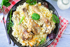 Rice with duck in a frying pan